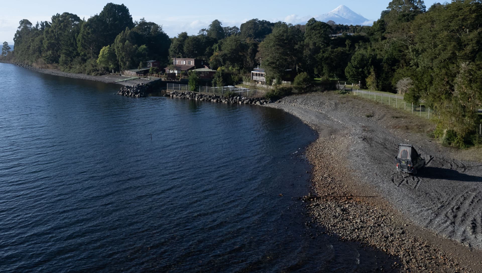 Scenic lakeside view with houses and mountains